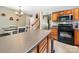 Well-lit kitchen featuring an island, breakfast nook, wood cabinets, and a black microwave/oven combo at 3446 Broadwick St, Charlotte, NC 28213
