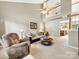 Spacious living room featuring a vaulted ceiling, fan, and staircase to the upper floor at 3446 Broadwick St, Charlotte, NC 28213