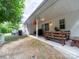A covered patio with a picnic table, grill and yard access for outdoor living and entertaining at 3446 Broadwick St, Charlotte, NC 28213