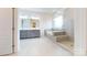 Bright bathroom featuring double vanity, soaking tub, and glass enclosed shower at 3719 Wave Rock Ct, Fort Mill, SC 29707