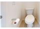 Close up of a white elongated toilet with wood tile floors in a bathroom at 3719 Wave Rock Ct, Fort Mill, SC 29707