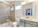 A modern bathroom features a glass-enclosed shower, white toilet, and a gray vanity with a white countertop at 3719 Wave Rock Ct, Fort Mill, SC 29707
