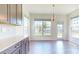 Bright dining area with large windows offering scenic views and a decorative light fixture at 3719 Wave Rock Ct, Fort Mill, SC 29707