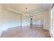 Elegant dining room featuring hardwood floors, wainscoting, a tray ceiling, and a modern chandelier at 3719 Wave Rock Ct, Fort Mill, SC 29707