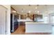 A modern kitchen featuring stainless steel appliances, a large island with a white countertop, and stylish pendant lighting at 3719 Wave Rock Ct, Fort Mill, SC 29707