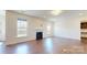 Spacious living room with hardwood floors, a fireplace, and large windows providing plenty of natural light at 3719 Wave Rock Ct, Fort Mill, SC 29707
