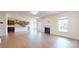 Bright living room with hardwood floors, fireplace, and views of the kitchen and backyard at 3719 Wave Rock Ct, Fort Mill, SC 29707
