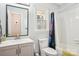 Clean bathroom featuring a gray vanity, toilet, bathtub, and decorative mirror at 3810 Selwyn Farms Ln # 3, Charlotte, NC 28209