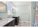 Bathroom featuring double vanity with marble countertops, stylish mirrors, and ceramic tile flooring at 3810 Selwyn Farms Ln # 3, Charlotte, NC 28209