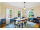 Charming dining room featuring stylish blue rug and natural light from the multiple windows at 3810 Selwyn Farms Ln # 3, Charlotte, NC 28209