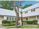 Charming home exterior with a light-colored facade, black shutters, metal roof, and beautiful landscaping at 3810 Selwyn Farms Ln # 3, Charlotte, NC 28209