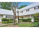 Charming home exterior with a light-colored facade, black shutters, metal roof, and beautiful landscaping at 3810 Selwyn Farms Ln # 3, Charlotte, NC 28209