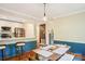 Open-concept kitchen and dining area with stainless steel appliances and wood floors at 3810 Selwyn Farms Ln # 3, Charlotte, NC 28209