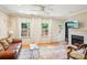 Bright and airy living room featuring a fireplace, leather sofa, and hardwood floors at 3810 Selwyn Farms Ln # 3, Charlotte, NC 28209