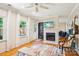 Bright living room with hardwood floors, fireplace, and large windows with curtains at 3810 Selwyn Farms Ln # 3, Charlotte, NC 28209