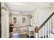Bright living room with wood floors, large windows, and a stylish staircase at 3810 Selwyn Farms Ln # 3, Charlotte, NC 28209