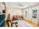 Cozy living room featuring hardwood floors, ceiling fan, and a comfortable leather sofa at 3810 Selwyn Farms Ln # 3, Charlotte, NC 28209