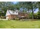 Sprawling backyard featuring a deck, lush landscaping, and a well-maintained lawn at 3909 Black Sycamore Dr, Charlotte, NC 28226