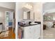 Convenient bathroom with a single sink, granite countertop, white cabinet, and views of a bedroom and hallway at 3909 Black Sycamore Dr, Charlotte, NC 28226