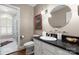Bright bathroom featuring granite countertop and access to a shower room with shuttered windows at 3909 Black Sycamore Dr, Charlotte, NC 28226