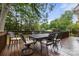 Spacious stained deck with a table and chairs, ideal for outdoor dining and relaxation, surrounded by lush green trees at 3909 Black Sycamore Dr, Charlotte, NC 28226