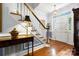 Elegant entryway with hardwood floors, staircase, and stylish light fixture creating a welcoming ambiance at 3909 Black Sycamore Dr, Charlotte, NC 28226