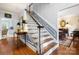 Inviting entryway with beautiful hardwood floors, staircase, and a glimpse into the dining room at 3909 Black Sycamore Dr, Charlotte, NC 28226