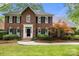 Lovely brick home showcasing manicured landscaping, black shutters, and a charming front entrance at 3909 Black Sycamore Dr, Charlotte, NC 28226