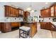 Gourmet kitchen featuring wood cabinetry, granite countertops, and an island with seating at 3909 Black Sycamore Dr, Charlotte, NC 28226