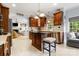 Stylish kitchen with wooden cabinets, stainless steel appliances, and an island overlooking the living area at 3909 Black Sycamore Dr, Charlotte, NC 28226