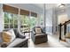 Bright living area with comfortable armchairs, large windows offering a view of the backyard, and neutral interior decor at 3909 Black Sycamore Dr, Charlotte, NC 28226