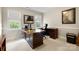 Bright office with a large desk, two windows with roller shades, and a comfortable office chair at 3909 Black Sycamore Dr, Charlotte, NC 28226