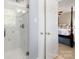Neat tiled shower room featuring glass doors and view into the bedroom at 3909 Black Sycamore Dr, Charlotte, NC 28226