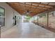 Expansive covered back porch perfect for outdoor living, featuring ceiling fans and a view of the backyard at 392 Winecoff Woods Nw Dr, Concord, NC 28027
