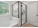 Modern bathroom featuring a glass-enclosed shower and a luxurious soaking tub at 392 Winecoff Woods Nw Dr, Concord, NC 28027