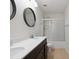 Modern bathroom with double vanity, sleek mirrors, and a glass-enclosed shower, combining style and functionality at 392 Winecoff Woods Nw Dr, Concord, NC 28027