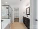 Bright bathroom features a tub/shower, double vanity, and access to a walk-in closet at 392 Winecoff Woods Nw Dr, Concord, NC 28027