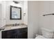 Modern half-bathroom features granite countertop, modern fixtures, and dark cabinets at 392 Winecoff Woods Nw Dr, Concord, NC 28027