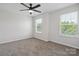 Bright bedroom features neutral walls, carpet floors, a ceiling fan, and plenty of natural light from the windows at 392 Winecoff Woods Nw Dr, Concord, NC 28027