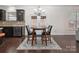 Cozy dining area adjacent to the kitchen with hardwood floors, chandelier, and French doors at 392 Winecoff Woods Nw Dr, Concord, NC 28027