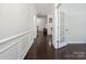 Inviting hallway with dark hardwood floors, white trim, and natural light leads to the living areas at 392 Winecoff Woods Nw Dr, Concord, NC 28027