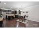 Open concept kitchen with dark cabinets, stainless steel appliances, and dining area at 392 Winecoff Woods Nw Dr, Concord, NC 28027