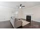 Bright living room features dark wood floors, fireplace, and comfortable seating, creating a cozy atmosphere at 392 Winecoff Woods Nw Dr, Concord, NC 28027