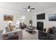 Bright living room features a fireplace, large windows, ceiling fan, and stylish contemporary furniture at 392 Winecoff Woods Nw Dr, Concord, NC 28027