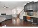 Open-concept living area with hardwood floors, fireplace, adjacent dining area and built-in desk with granite countertop at 392 Winecoff Woods Nw Dr, Concord, NC 28027