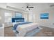 Staged main bedroom with a king bed, blue accents, and serene artwork at 392 Winecoff Woods Nw Dr, Concord, NC 28027