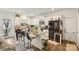 Bright kitchen boasts white cabinets, granite countertops, and stainless steel refrigerator at 3985 Village Nw Blvd, Conover, NC 28613
