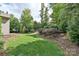 A well-maintained lawn and verdant landscaping in the backyard create a serene and picturesque outdoor setting at 4018 Harmattan Dr, Denver, NC 28037