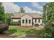 Back exterior of home with a well-maintained lawn and a patio with a grill and outdoor seating at 4018 Harmattan Dr, Denver, NC 28037