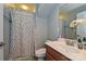 Cozy bathroom featuring a shower with a patterned curtain and a modern vanity with a sleek sink at 4018 Harmattan Dr, Denver, NC 28037
